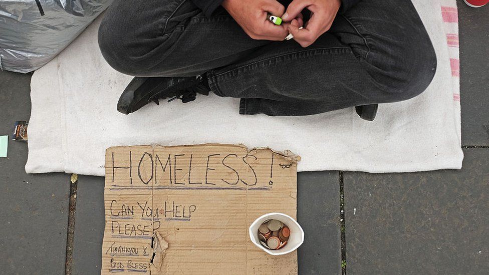 Homeless person with sign