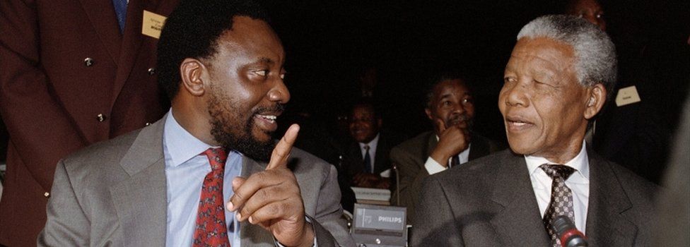 ANC Secretary General Cyril Ramaphosa (L) chats with Nelson Mandela after arrival at the world Trade Center, in Kempton Park 18 November 1993, where political leaders formally endorsed a constitutional blueprint that will end 300 years of white minority rule.