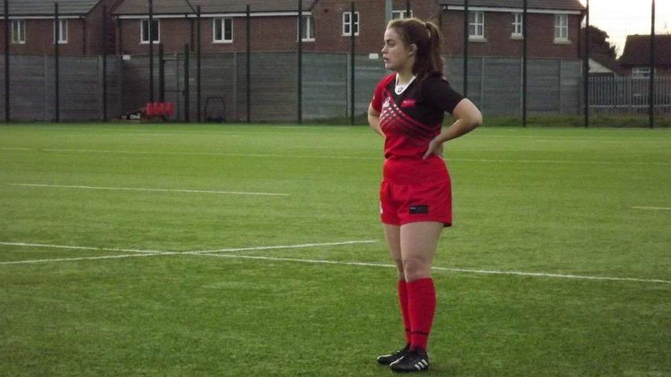 Maddy Lawrence standing on a rugby pitch