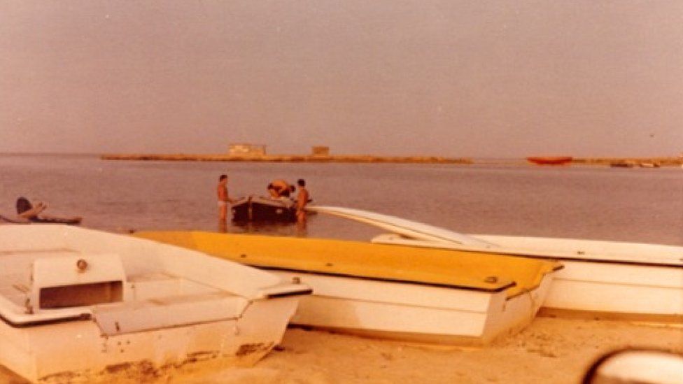 Boats at Arous village, with Mossad agents in the background
