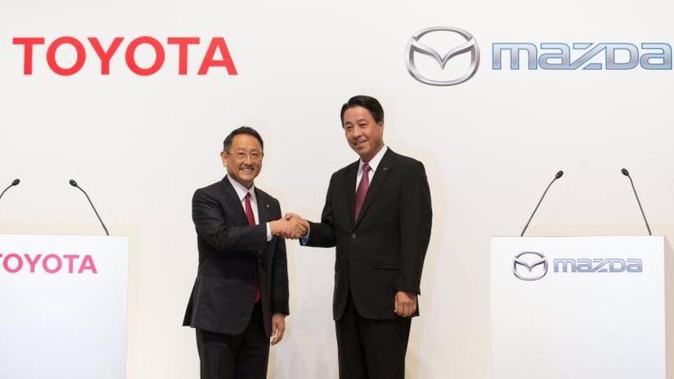 Toyota Motor Corp. President Akio Toyoda (L) and Mazda Motor Corporation President and CEO Masamichi Kogai (R)