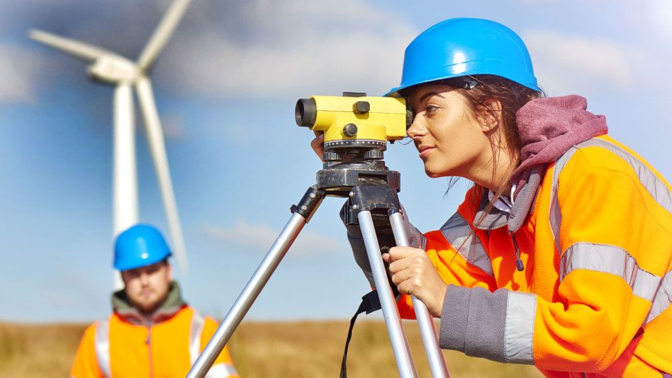 Stock image of a two wind farm engineers