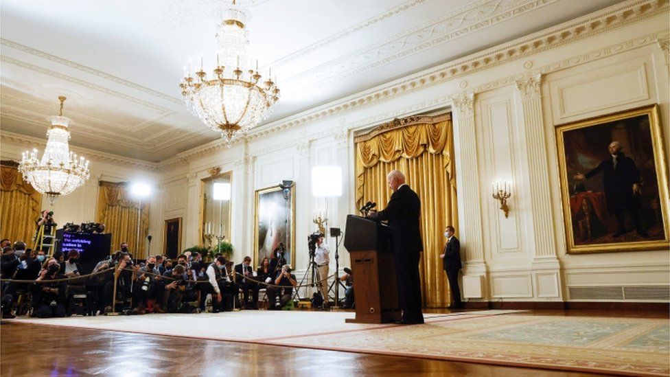 Joe Biden at a press conference with the media in front of him