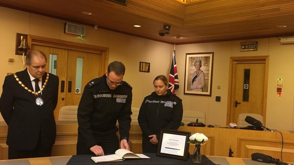 Officers sign book of condolences