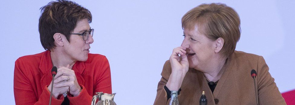 German Chancellor and leader of the German Christian Democrats (CDU) Angela Merkel and Annegret Kramp-Karrenbauer sit together during the federal executive board meeting on December 6, 2018 in Hamburg, Germany