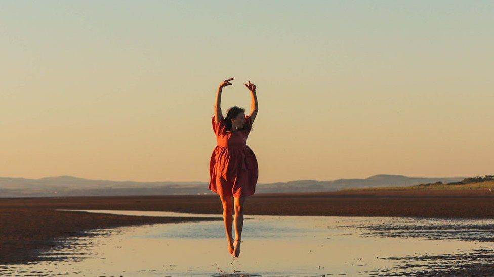 Woman jumping on a beach