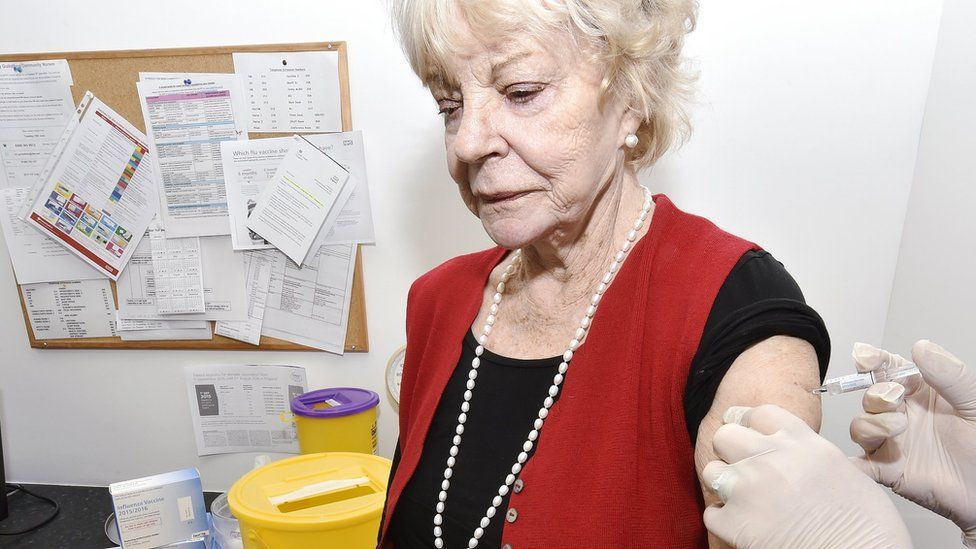 Old woman being getting the jab