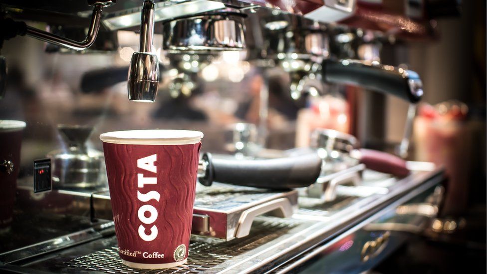 Costa Coffee cup on coffee machine