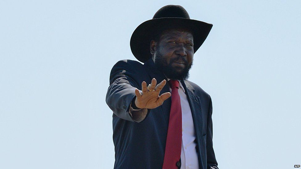 South Sudan President Salva Kiir waves at members of his cabinet as he boards a plane in Juba to attend an African Union (AU) summit in Malabo, Equatorial Guinea, on 25 June 2014