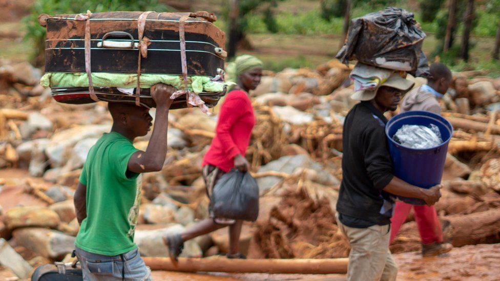 Cyclone survivors leave the Ngangu township with their belongings to Chimanimani Hotel in Zimbabwe - 18 March 2019