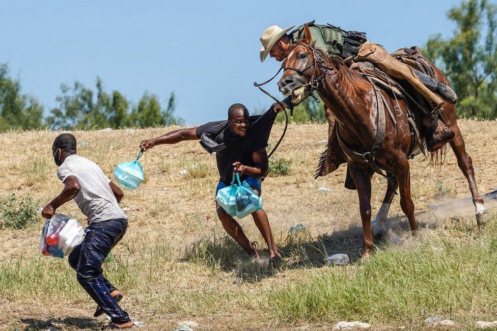 A United States Border Patrol agent on horseback tries to stop a Haitian migrant from entering an encampment on the banks of the Rio Grande near the Acuna Del Rio International Bridge in Del Rio, Texas, on 19 September 2021