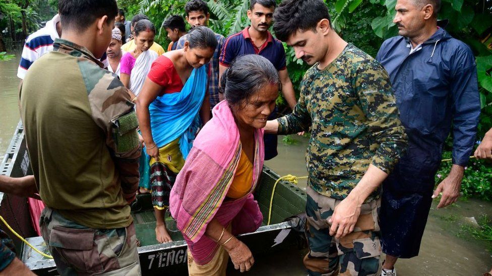 Army soldiers evacuate flood-affected villagers following heavy monsoon rainfalls in Rangia of Kamrup district, in India's Assam state on June 18, 2022.