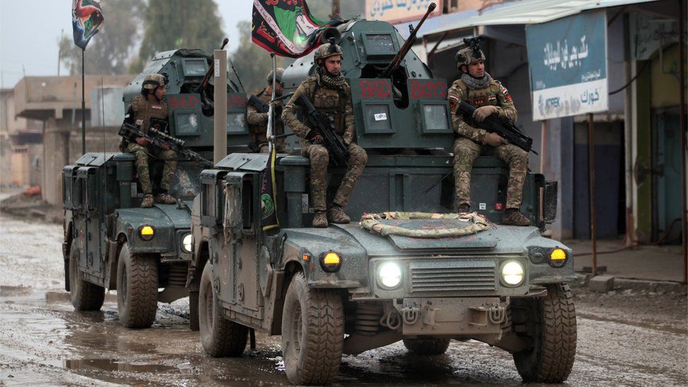 Iraqi pro-government forces patrol the eastern part of the embattled Iraqi city of Mosul, 28 December 2016