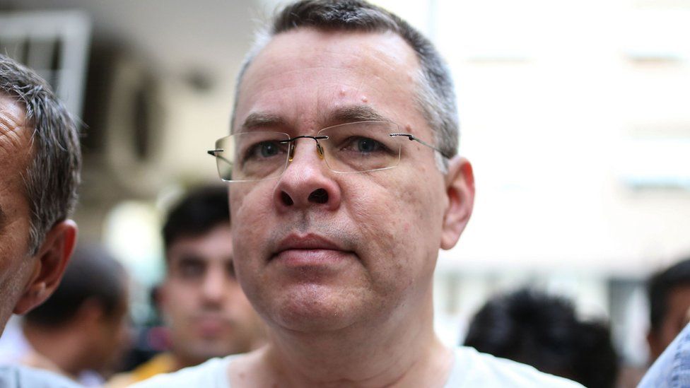 Andrew Brunson escorted by Turkish plain clothes police officers arrives at his house on July 25, 2018 in Izmir.