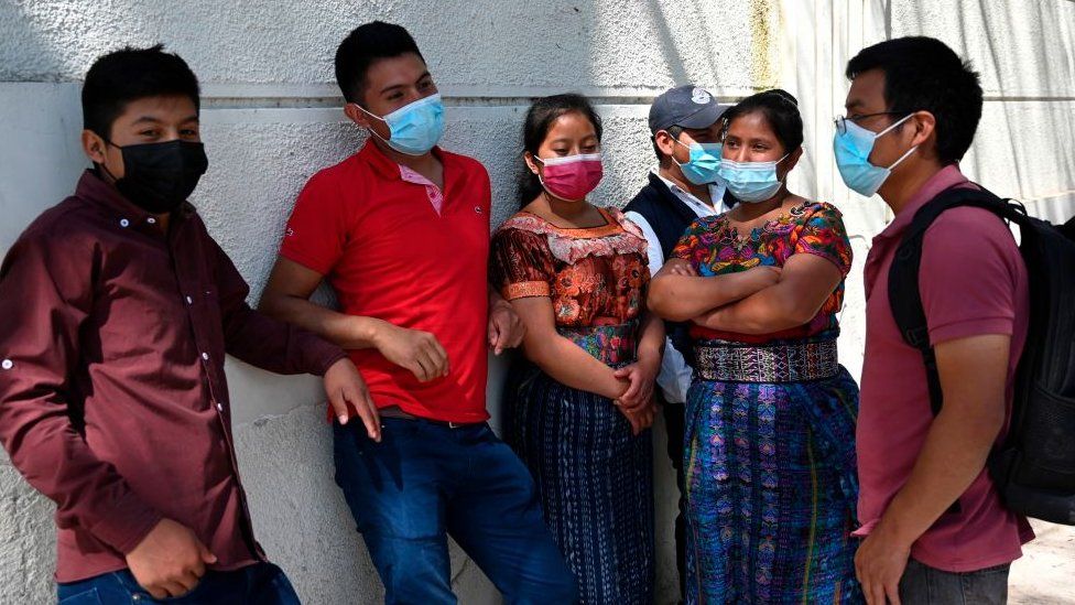 People remain outside the Ministry of Foreign Affairs in Guatemala City on January 25, 2021, after giving details of their relatives who might be in the group among people found burned to death on a rural road in the state of Tamaulipas, Mexico. -