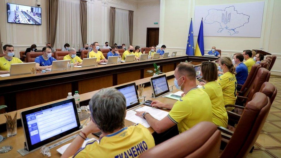 Ukrainian ministers wear the soccer national team's yellow-and-blue jerseys following Ukraine's defeat of Sweden in their Euro 2020 Round of 16 match as they attend a meeting of the government in Kyiv, Ukraine June 30, 2021