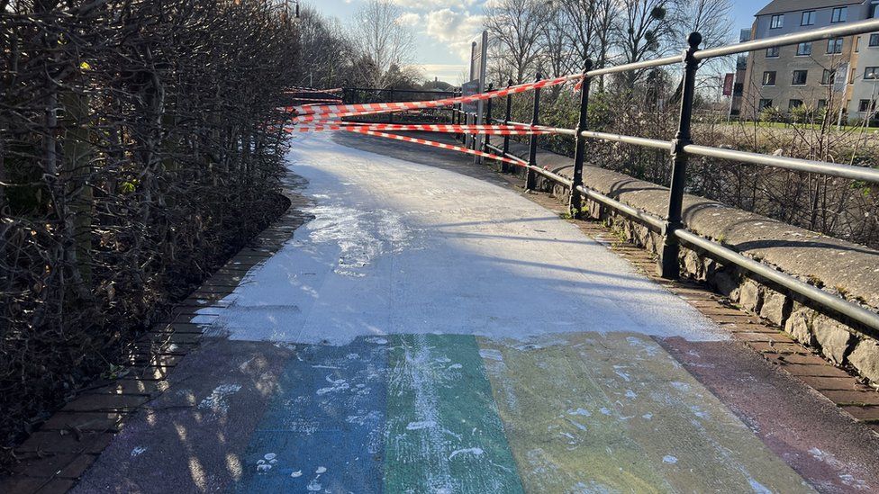 Rainbow walkway covered in white paint