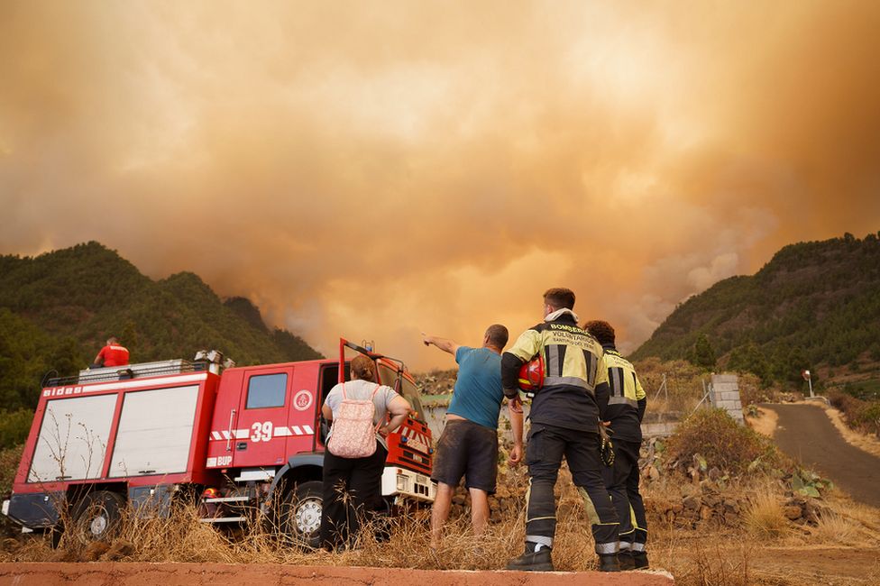 Firefighters arrive at the scene of a forest fire that originated in Candelaria, Tenerife
