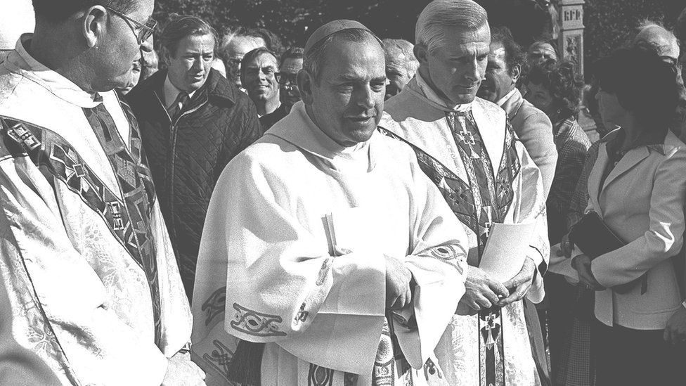 Archbishop of Armagh Tomás Ó Fiaich (centre) outside Armagh Cathedral in 1977