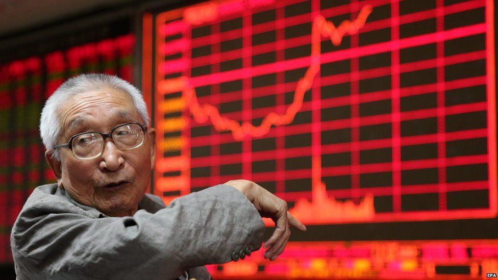 A stock investor gestures in front of an electronic screen at a brokerage firm in Shanghai, China