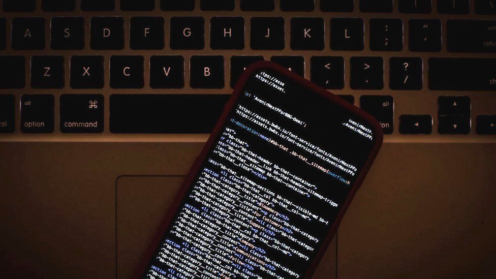 HTML code on an iPhone alongside a laptop, 22 January 2019