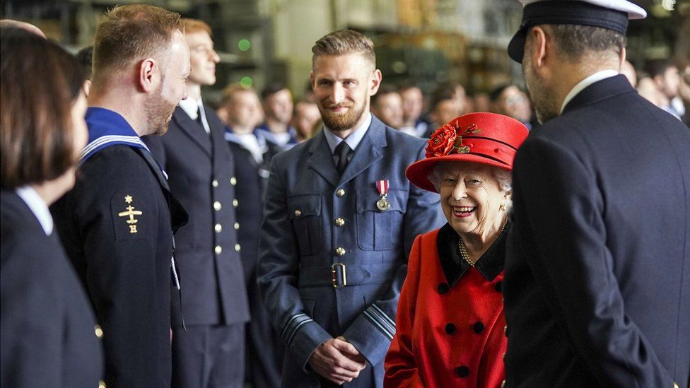 The Queen talking to people during a visit to HMS Queen Elizabeth in Portsmouth