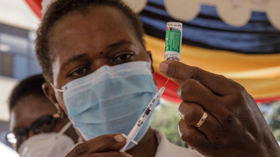 A health worker draws the AstraZeneca vaccine from a vial