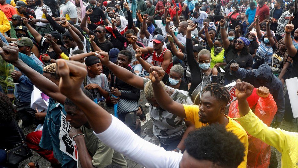 Demonstrators gesture during a protest over alleged police brutality, in Lagos, Nigeria, 14 October, 2020.