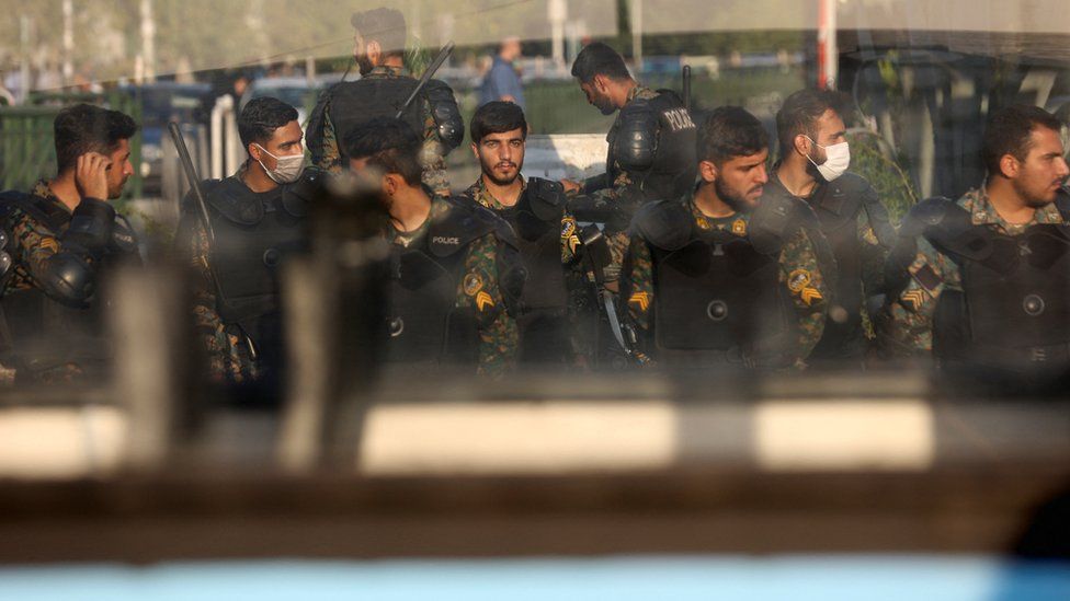 Iranian riot police stand in a street in Tehran, Iran (3 October 2022)