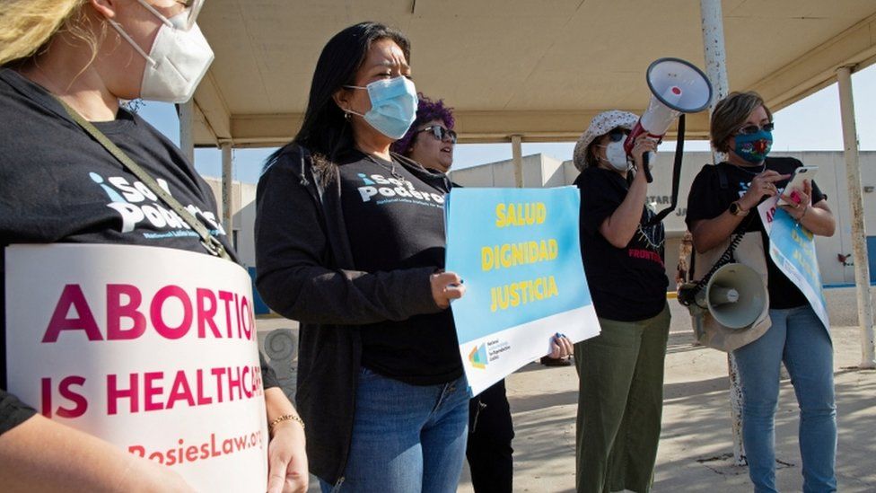 Protesters stand outside the Starr County Jail over abortion charge