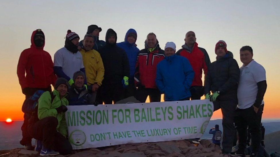 Fundraisers at the top of Pen y Fan after a sunset to sunrise cycle