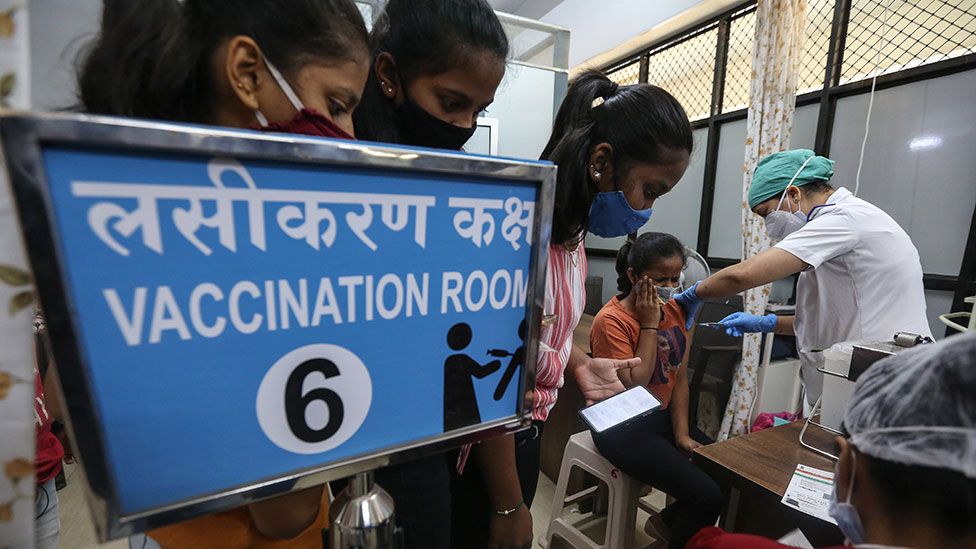 Women get vaccinated in India