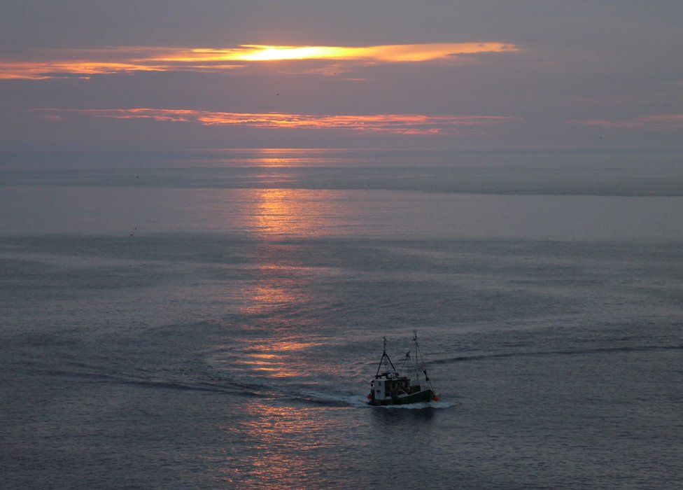 Fishing boat off St Abbs at sunrise