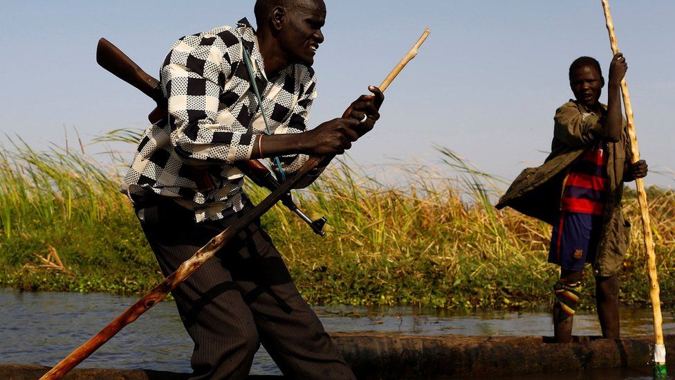 Armed man canoes