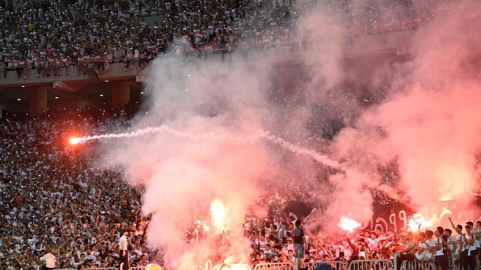 Zamalek fans light flares
