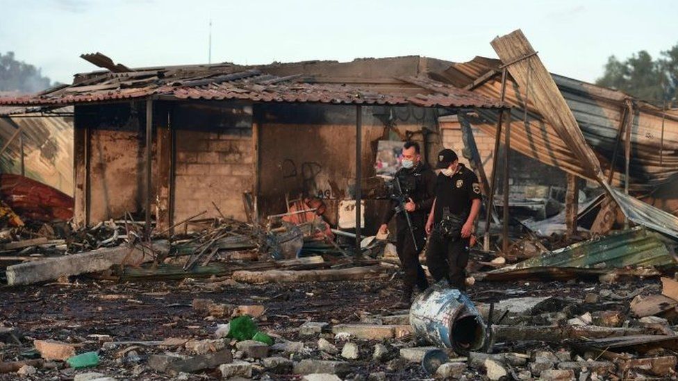 Fire fighters work amid the debris left by the huge blast (21 December 2016)