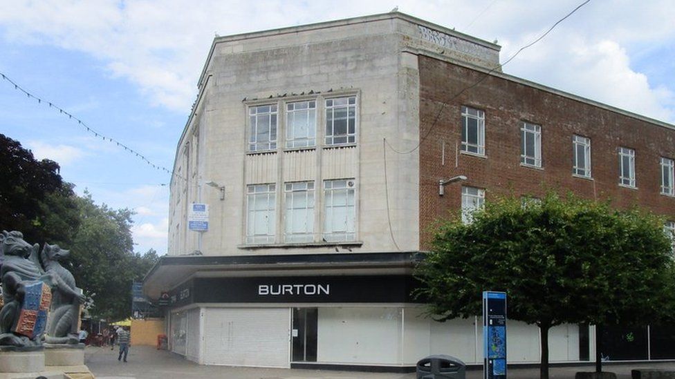 a building with a sign saying 'Burton'