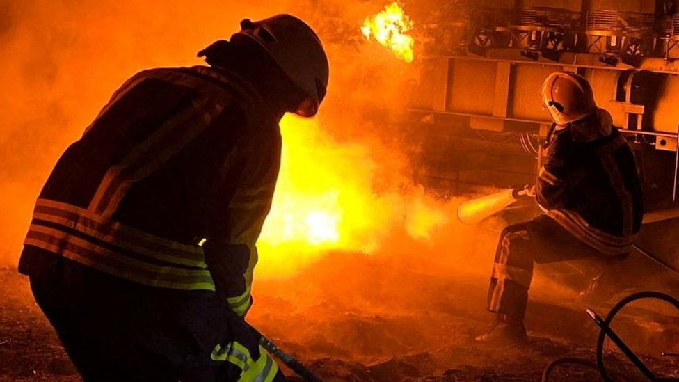 Firefighters attempt to put out a fire at an energy facility near Kyiv
