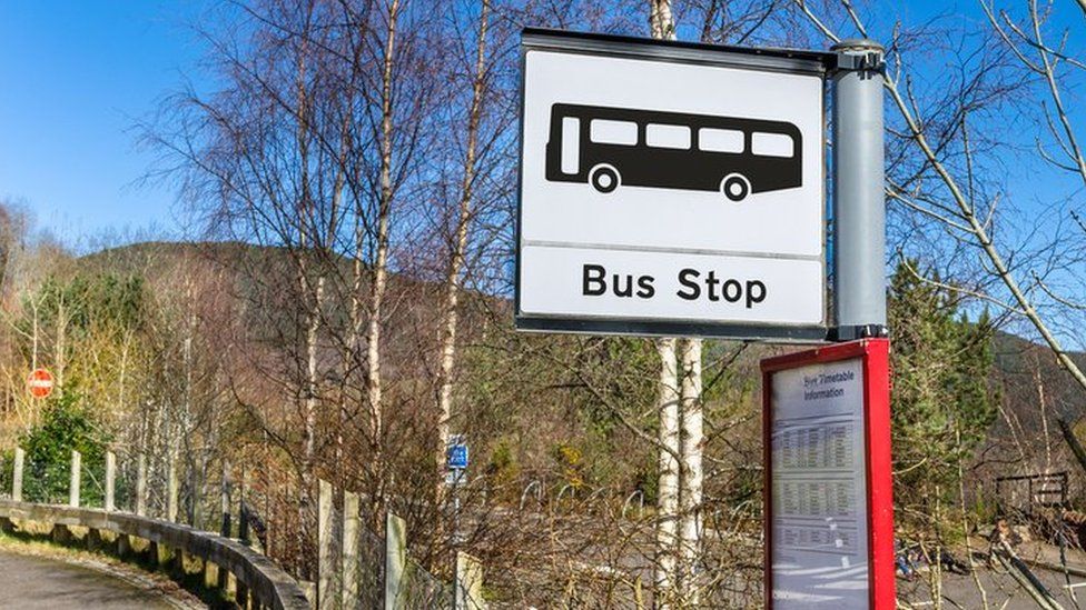 A bus stop sign in the countryside
