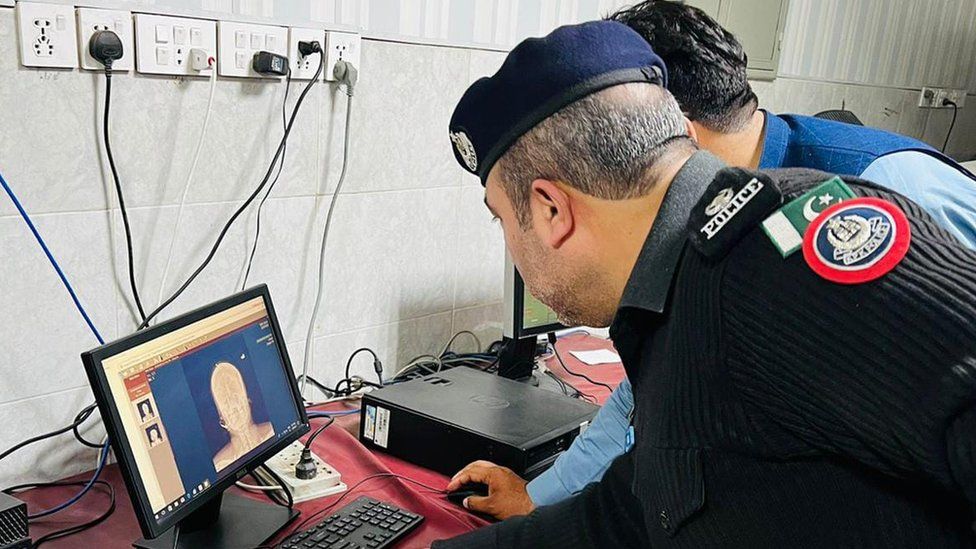 Police examining the x-ray of the woman's injury