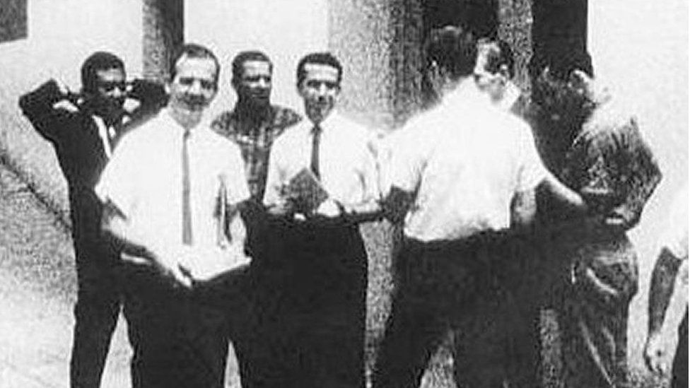 Lee Harvey Oswald, front left, standing next to man never identified by the Warren Commission, centre in white shirt, handing out leaflets for the Fair Play for Cuba Committee