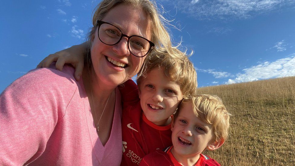 Sarah Knight on the beach with her two sons