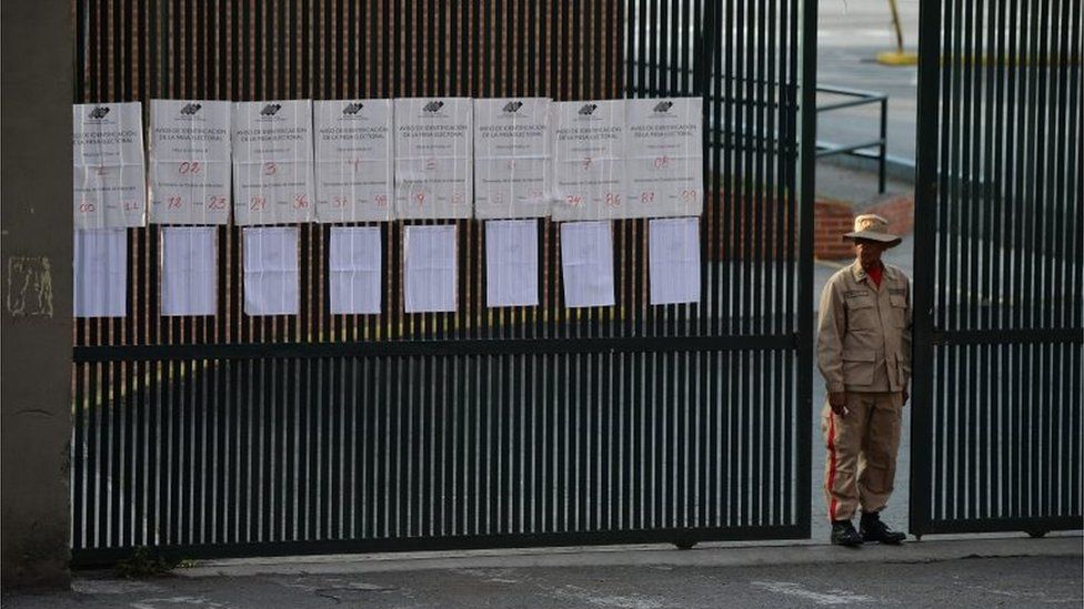 A Bolivarian militia stands guard at the gate of a school in Caracas after polling stations closed on election day in Venezuela, on May 20, 2018.