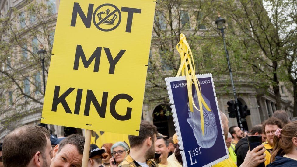 Protester holds a sign saying "not my King" in Trafalgar Square on Saturday 6 May