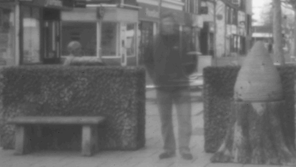 Pinhole photo of man on street