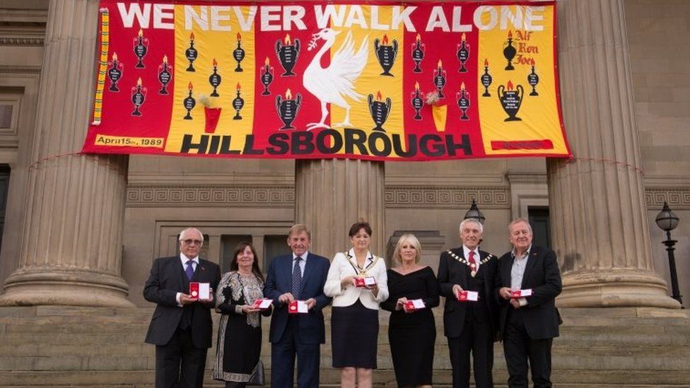 The Hillsborough victims' families, Prof Phil Scraton and Kenny and Marina Dalglish with their freedom medals