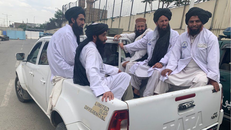 Maulvi Fatih and his officials use a pick up truck to get around