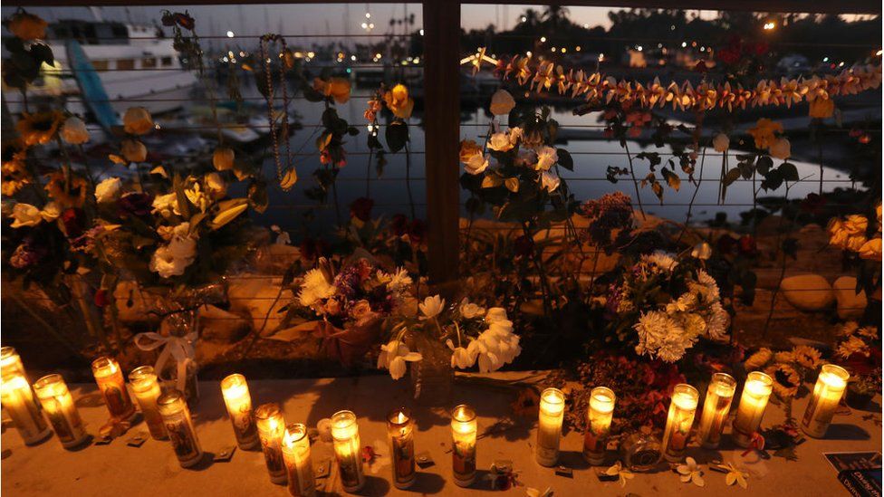Candles are lit in Santa Barbara Harbour at a makeshift memorial for victims of the Conception boat fire
