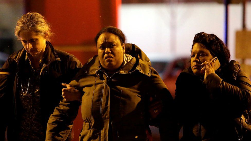 A woman is escorted outside Mercy Hospital after a gunman shot multiple people on November 19, 2018 in Chicago, Illinois
