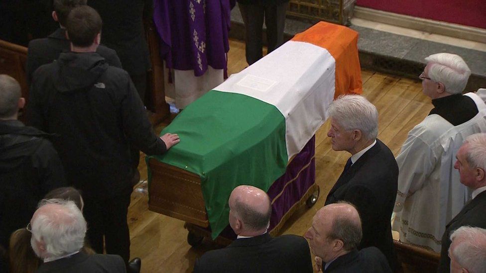 Former US President Bill Clinton beside the coffin of Martin McGuinness